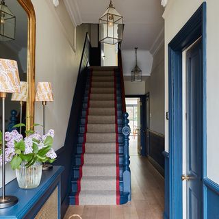 Blue staircase with red and beige runner
