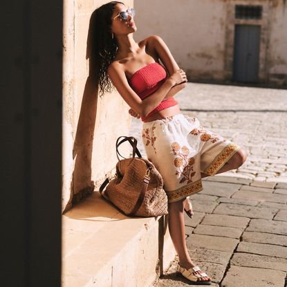 J.crew model wearing 7" Stratus Short in Dusty Periwinkle Block Print and leaning against a wall