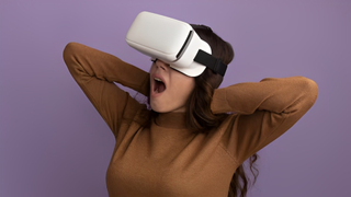 Woman wearing VR headset holds her neck