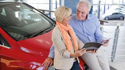 Old people looking at a car brochure © Juice Images / Alamy Stock Photo
