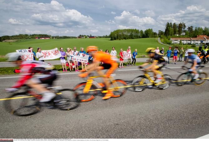 A peloton buzzes by