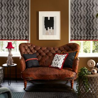 room with brown sofa and brown wall