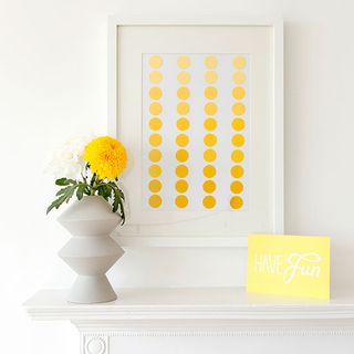 white wall with art frame and flower in vase