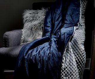 Luxome weighted blanket on an armchair.