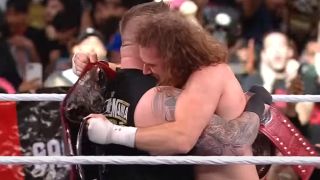 Kevin Owens and Sami Zayn embracing after winning the tag titles at WrestleMania 39
