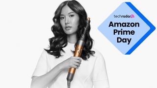 A woman using a Dyson Airwrap Origin with an Amazon Prime Day badge