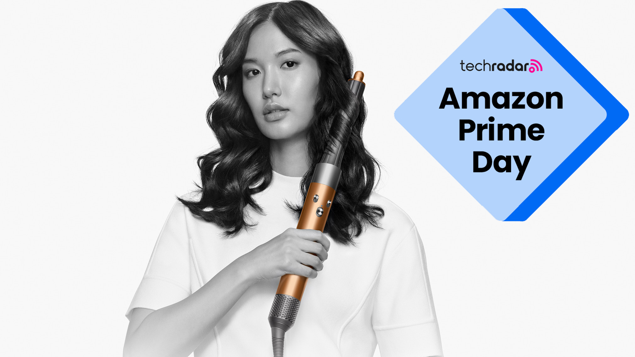 A woman using a Dyson Airwrap Origin with an Amazon Prime Day badge