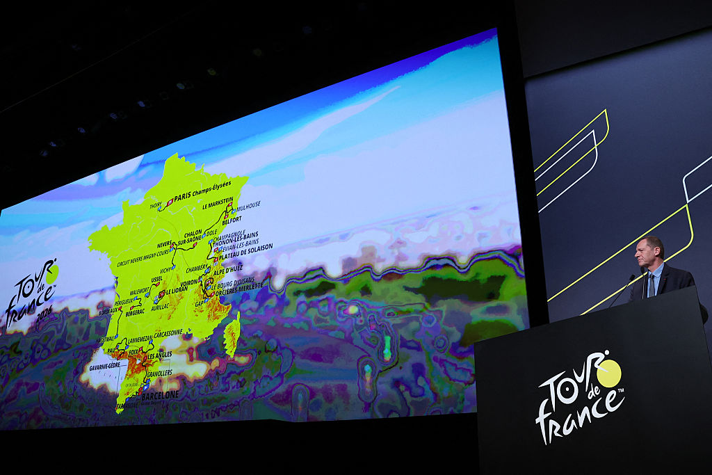 Tour de France General Director Christian Prudhomme addresses the audience in front of the map, showing the men&#039;s route, during the presentation of the official routes of the 2026 edition of the men&#039;s and women&#039;s Tour de France cycling race in Paris on October 23, 2025. (Photo by Anne-Christine POUJOULAT / AFP)