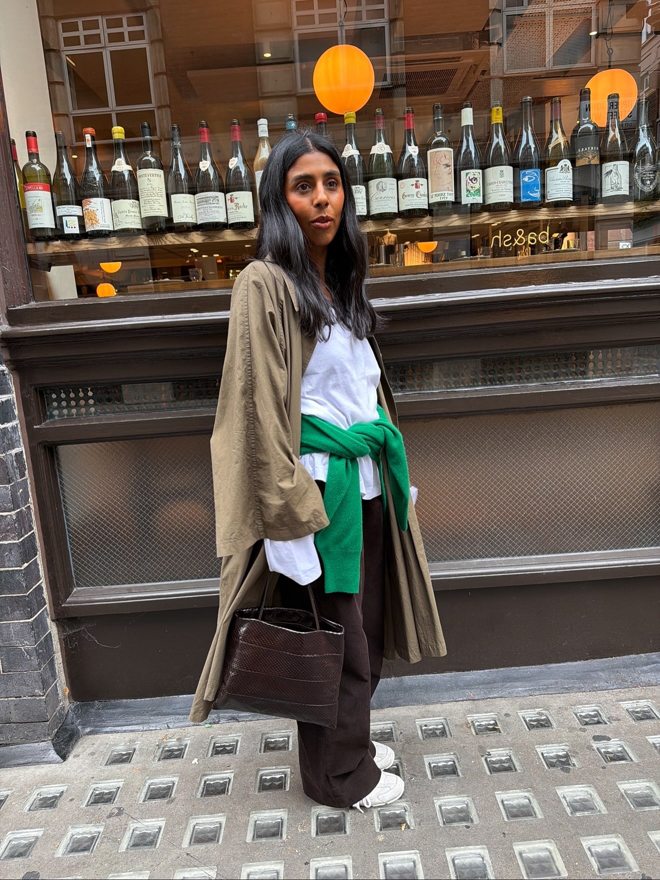 Woman wearing an eel-embossed bag.