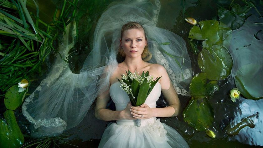 A still of Kirsten Dunst in a wedding dress in a pond from the movie Melancholia