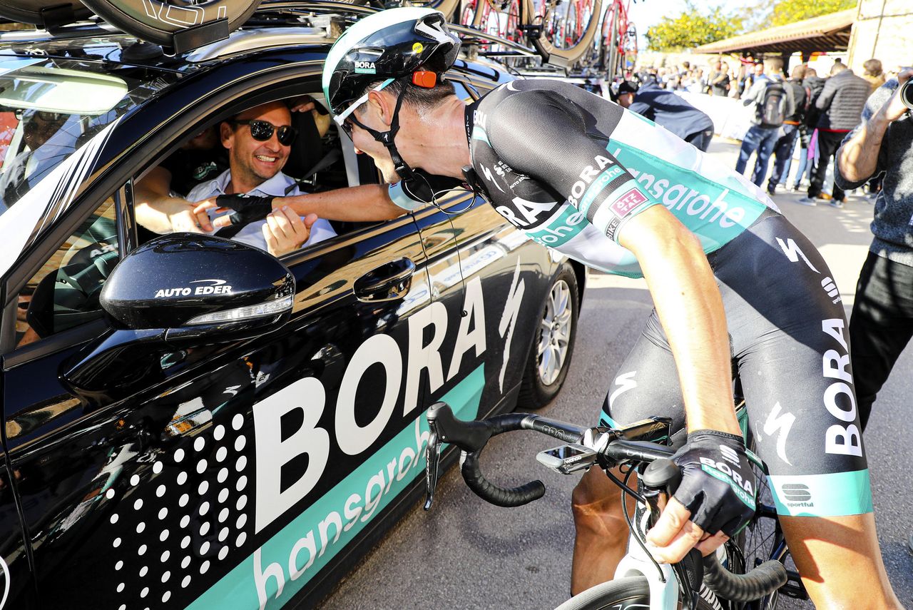 Emanuel Buchmann celebrates with his directeur sportif