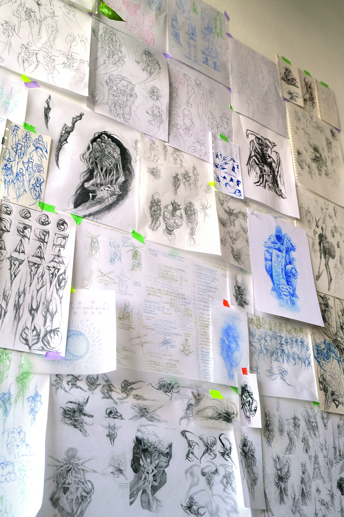 Tattoo art on paper sheets stuck to a wall