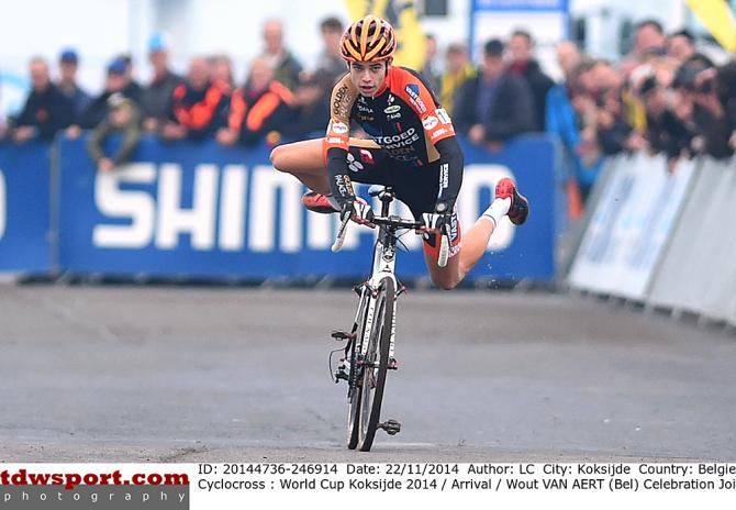 Wout Van Aert hops off and back on his bike as he cross the finish line in Koksijde