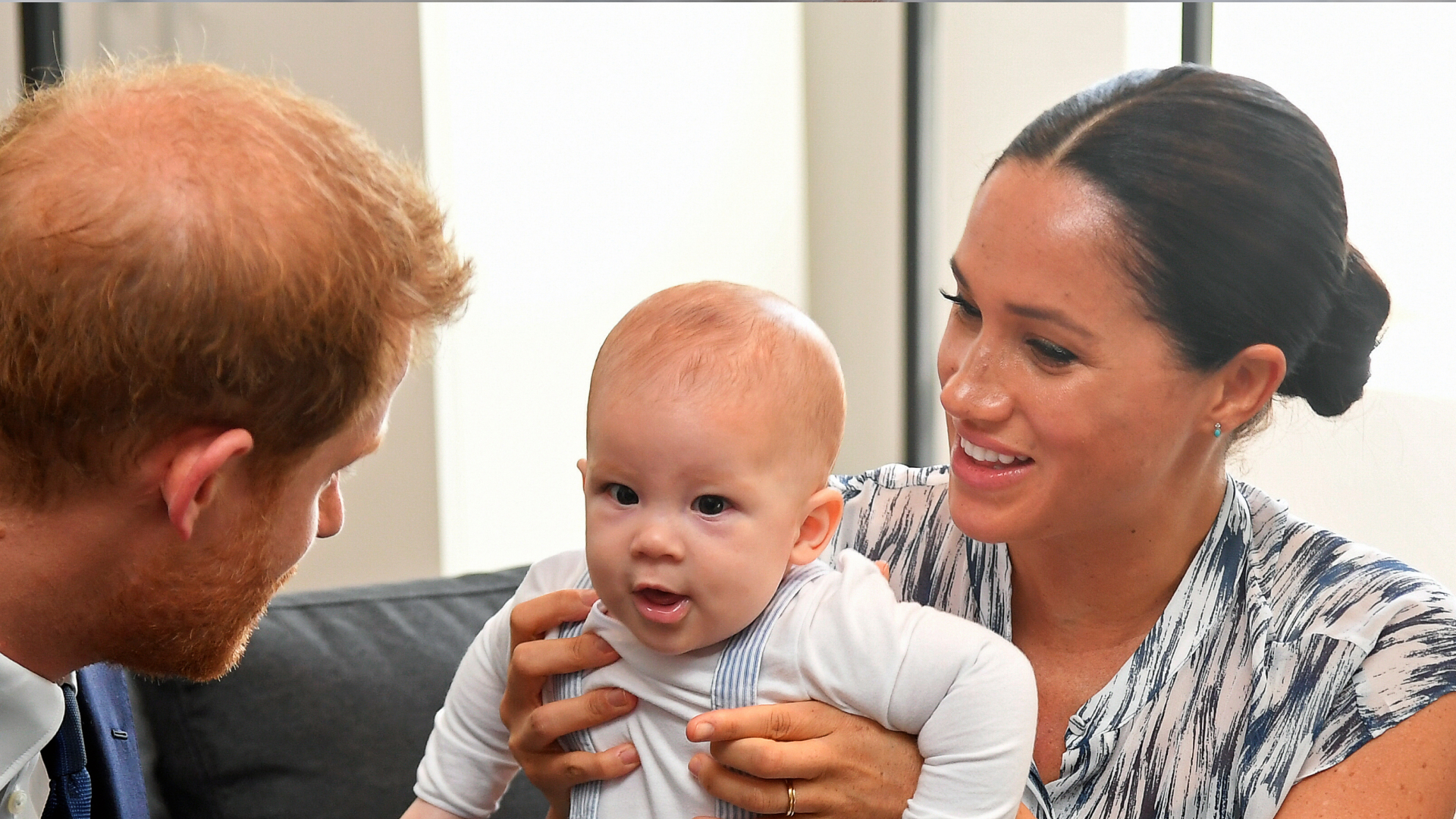 Meghan Markle holding baby Prince Archie and smiling