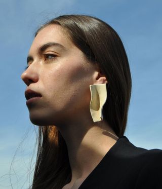 Binksy cermaic earrings worn on a model.