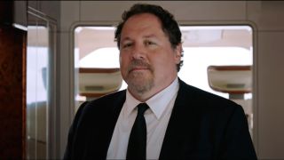 Jon Favreau smiles proudly in a jet in Spider-Man: Far From Home.