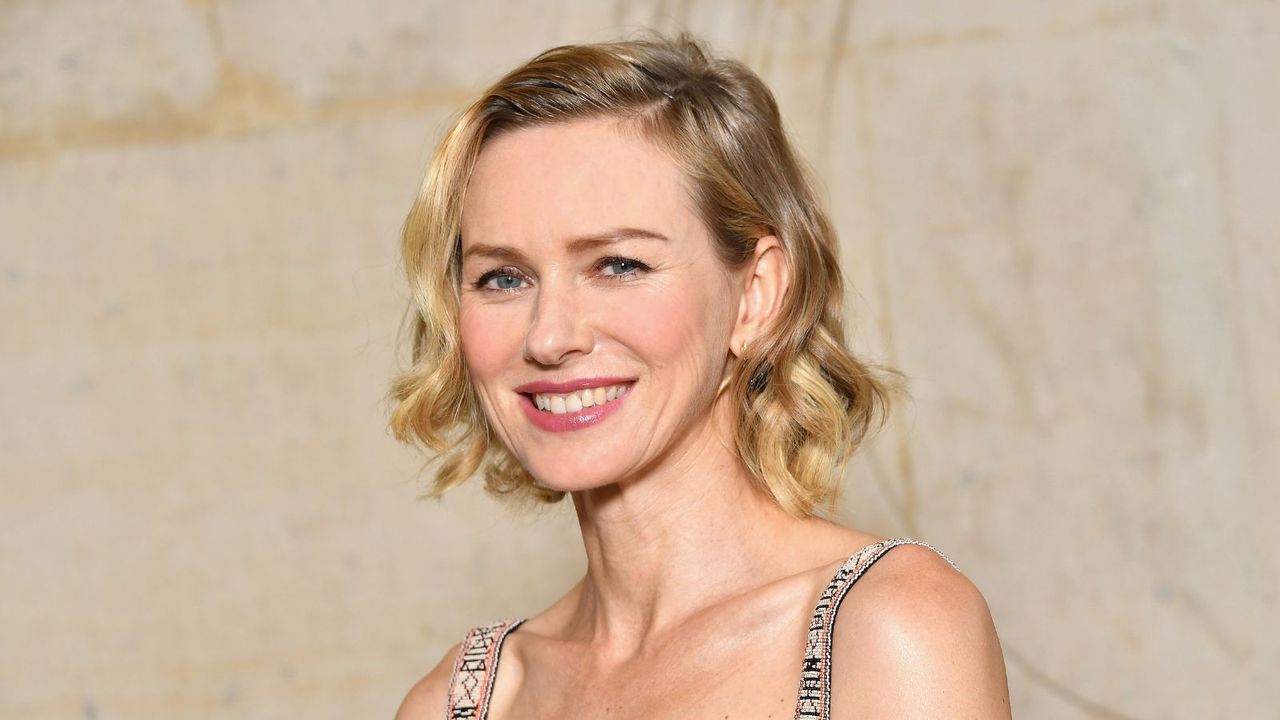 naomi watts on a tan background