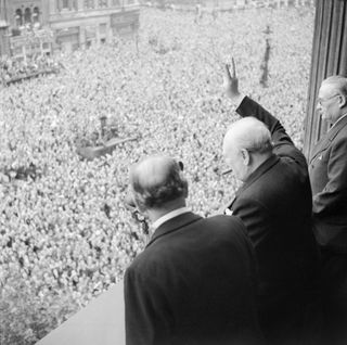 Prime Minister Churchill waves to crowds on May 8, 1945.