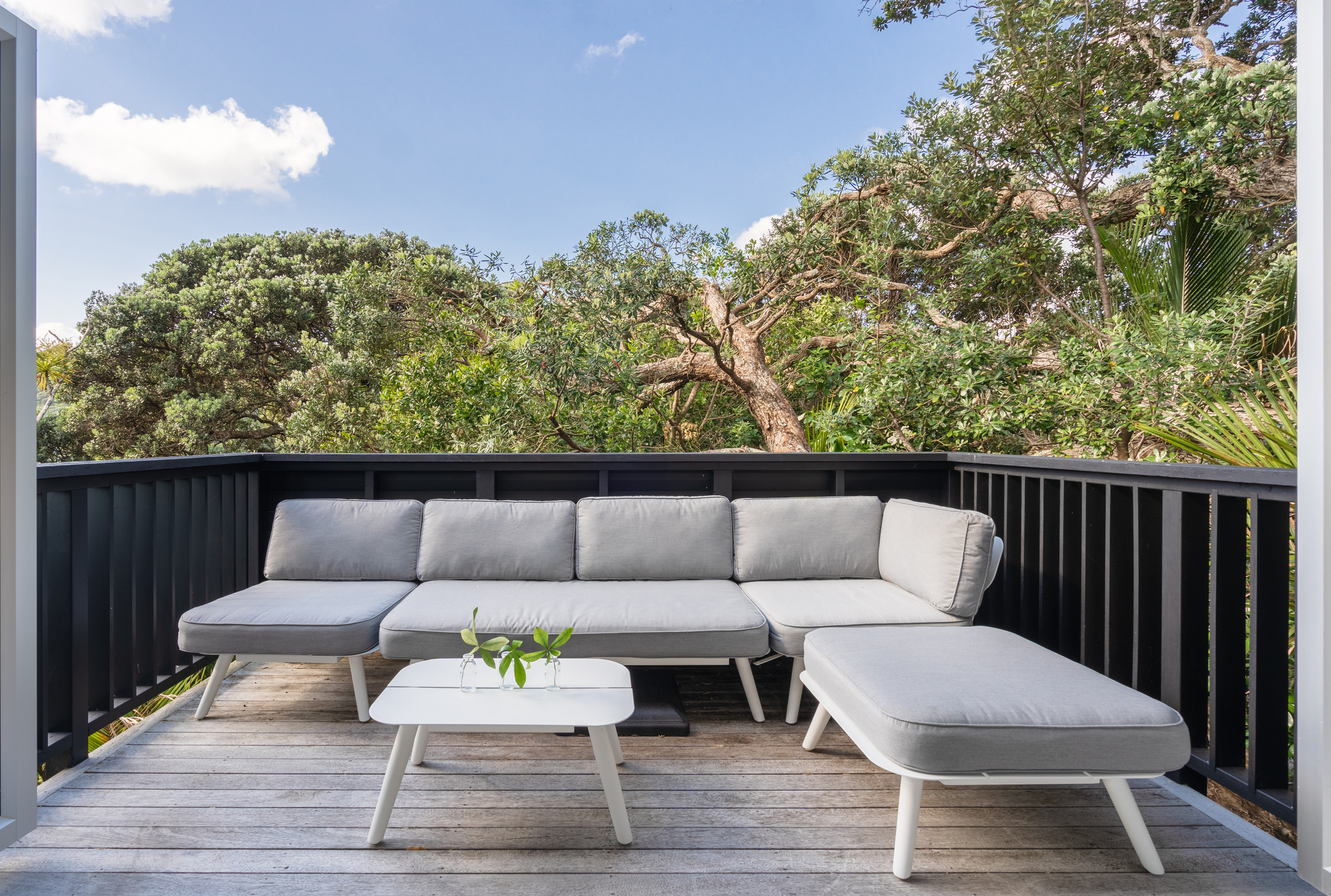 Simple contemporary balcony space with neutral decking