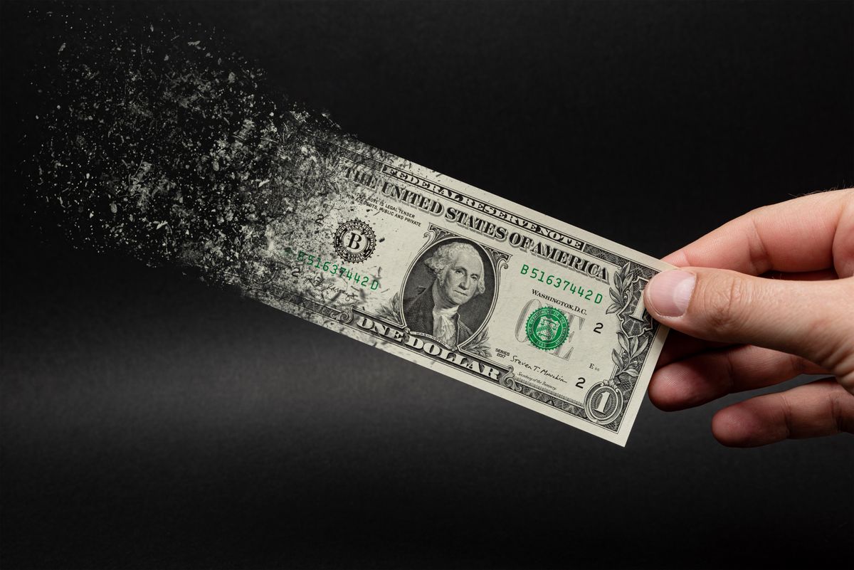 dollar bill disappearing due to inflation