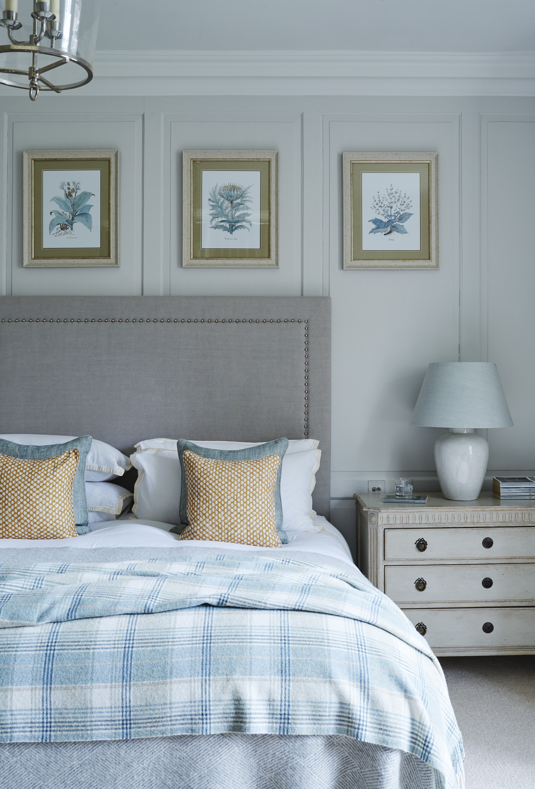 bedroom with bed dressed with throw and cushion