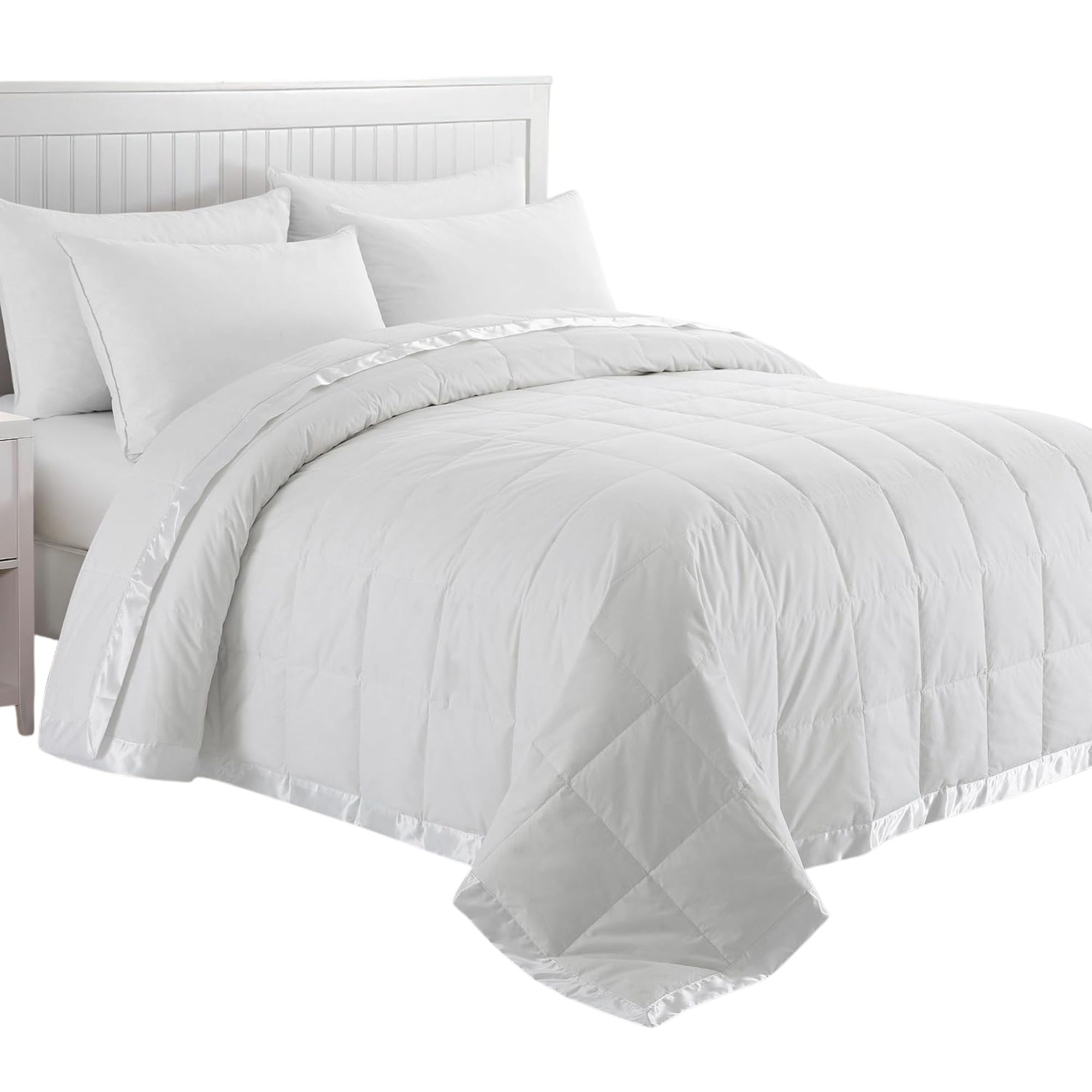 A white Puredown bed blanket on a white bedframe with white pillows and sheets