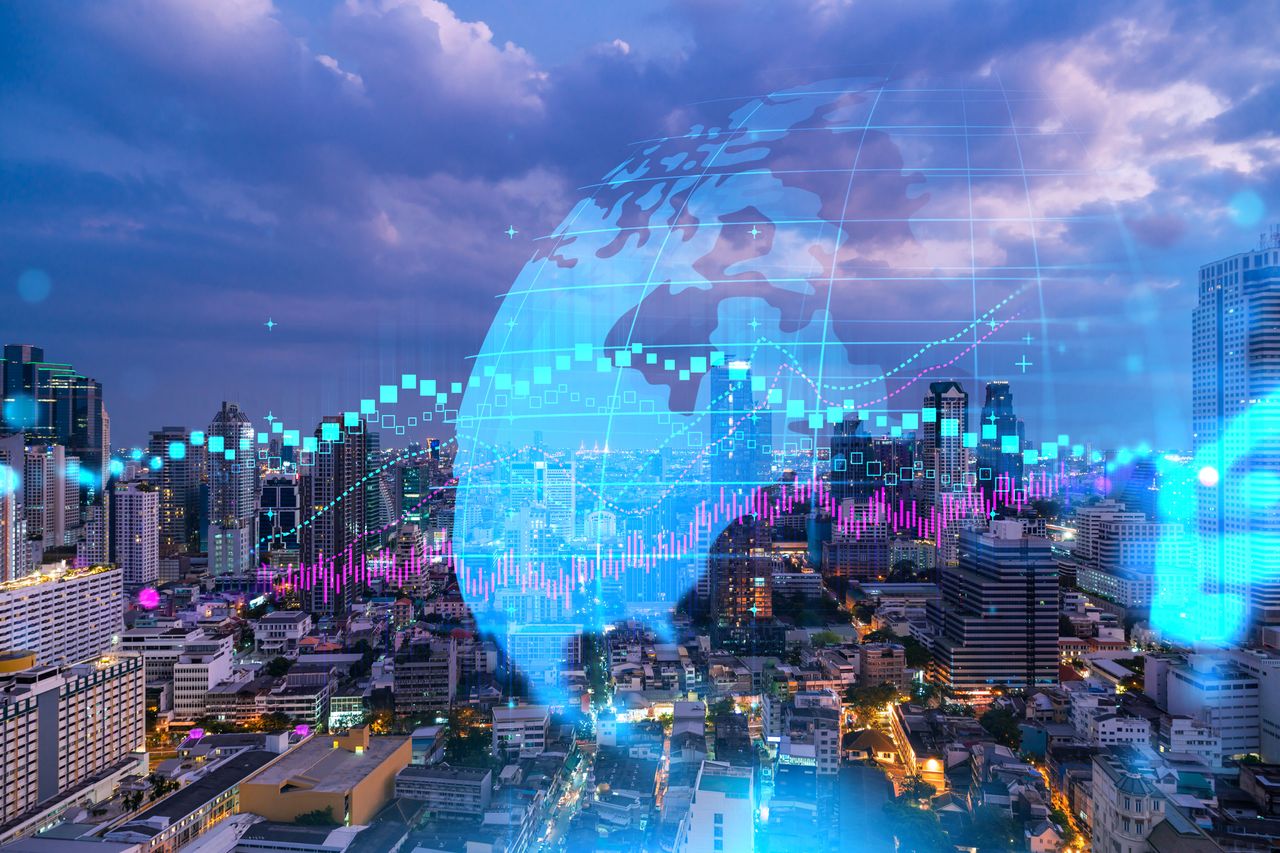 concept of emerging markets with digital globe and financial charts superimposed on city skyline