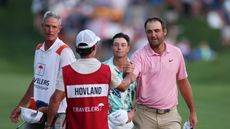 Scottie Scheffler shakes hands with Viktor Hovland's caddie