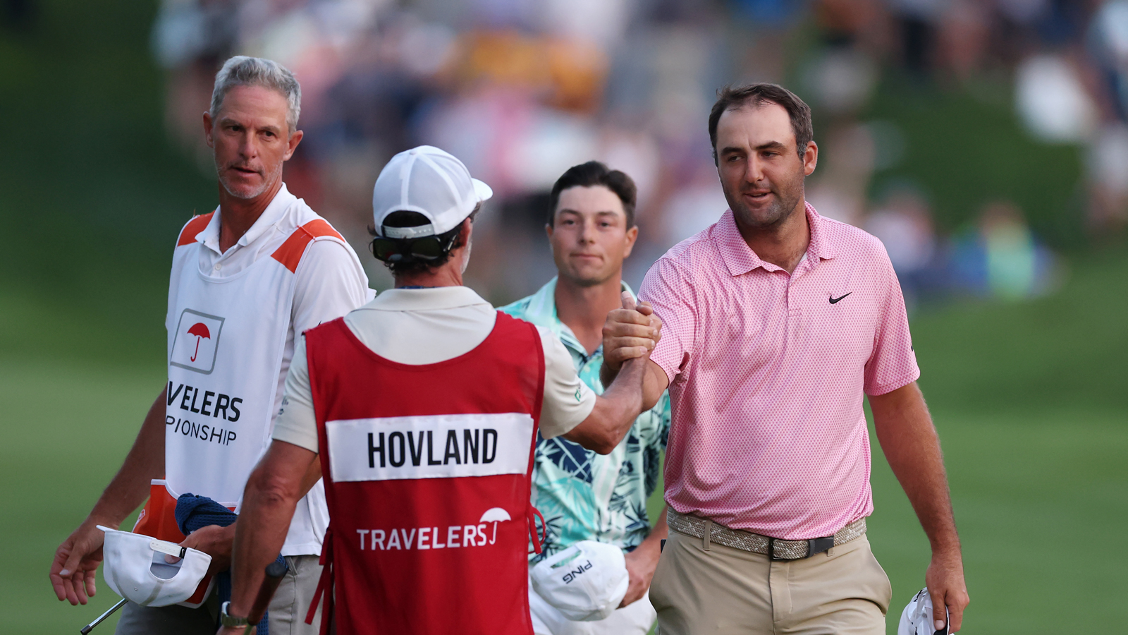 Scottie Scheffler shakes hands with Viktor Hovland's caddie