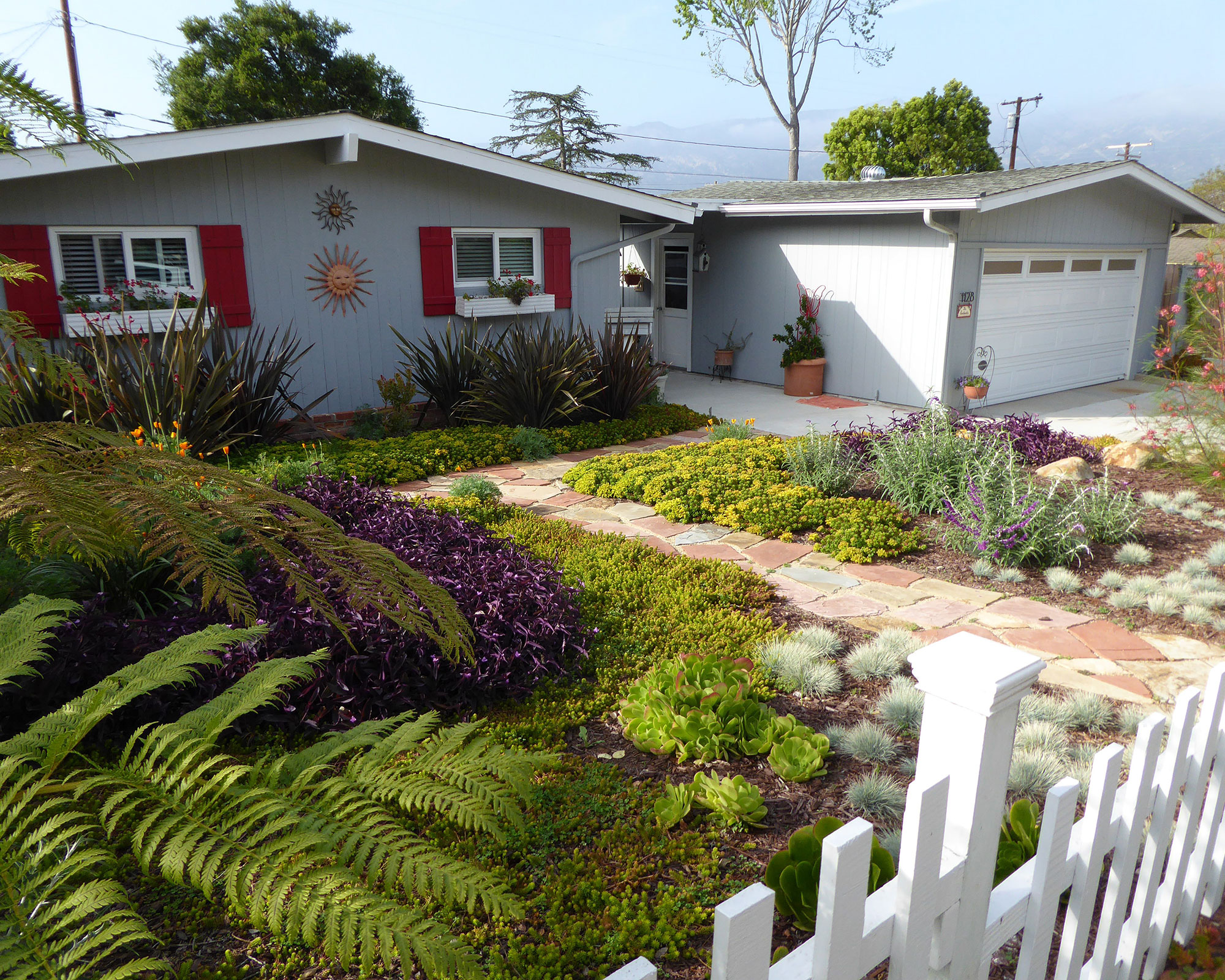 front yard with drought tolerant plants and colorful garden path