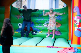 Jean Slater bounces on a bouncy castle