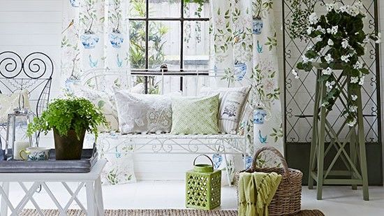 living area with white wall and curtain with wooden basket