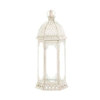 A cream table lantern with a domed top and three glass panels