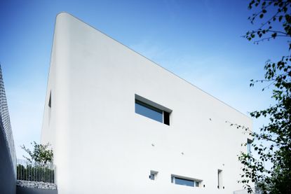 rounded house in South Korea is a white boxy composition with curved corners