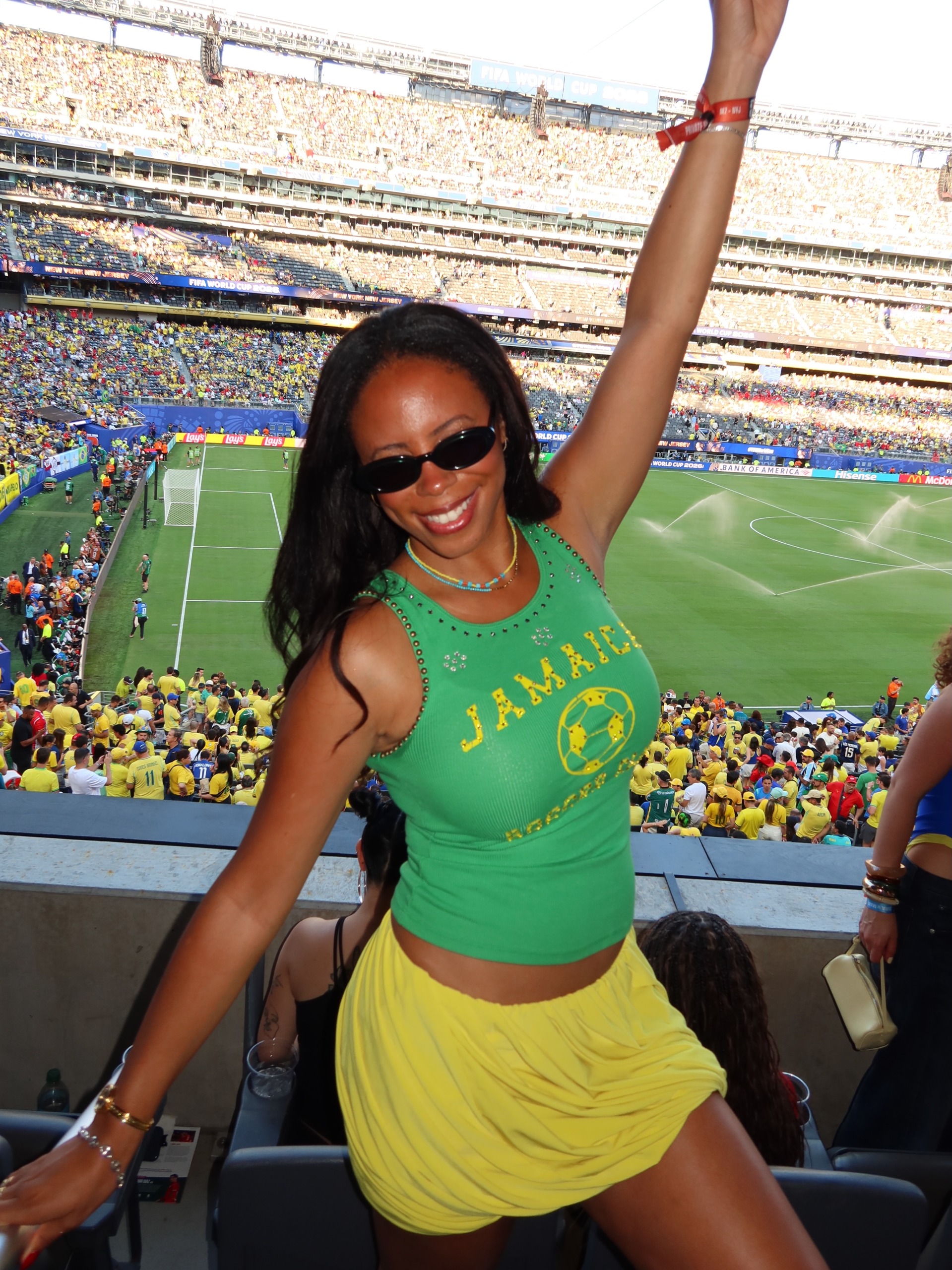 Woman wearing a logo tee and draped skirt.