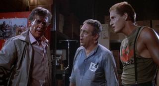 Three men covered in sweat and blood as they deliberate what to do