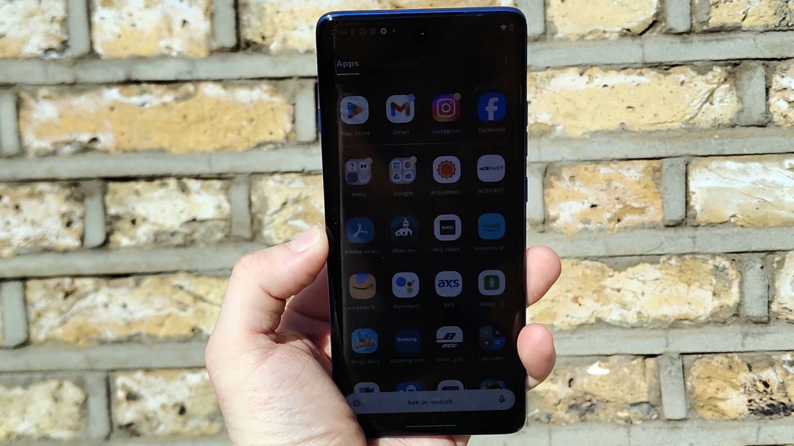 The Motorola Edge 60 Pro above a brick wall.