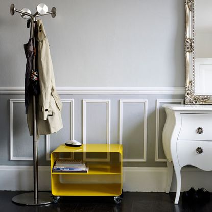 pale grey hallway with panelling and storage