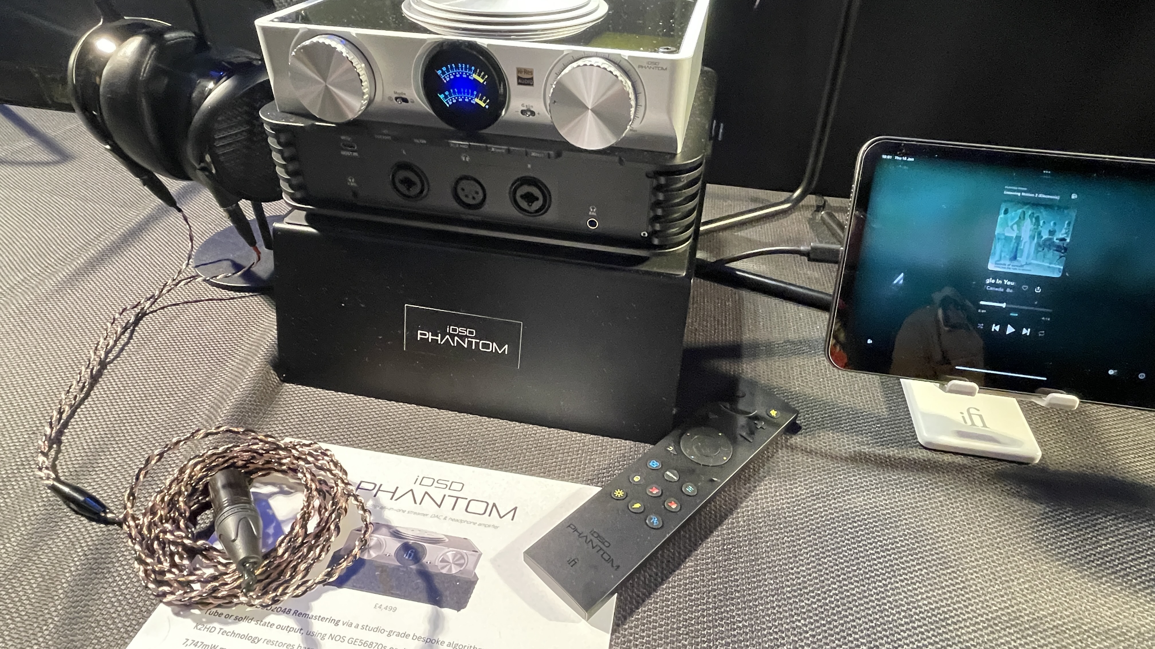 The formidable iFi iDSD Phantom in Tower Bridge, London, used with headphones and illuminating the front panel 