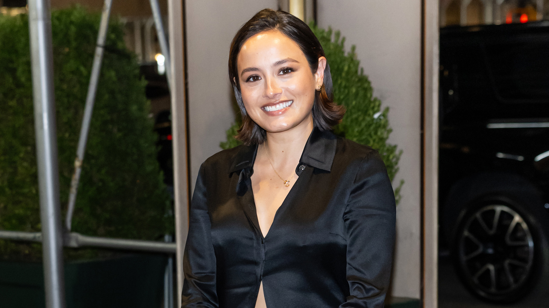Chase Sui Wonders wearing a black top, black miniskirt, and black slingback heels at a Chanel dinner