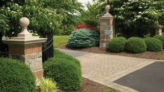 large brick piers with stone tops at entrance to driveway