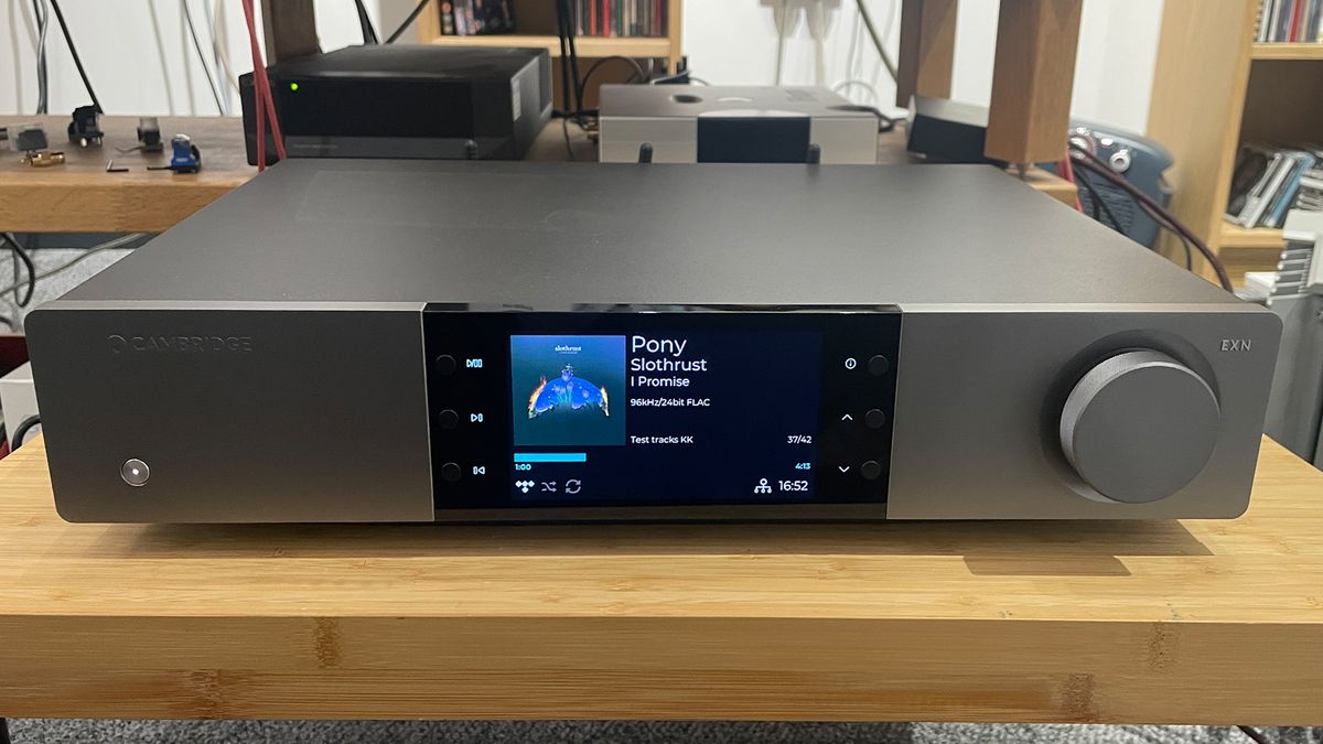 Cambridge Audio EXN100 music streamer from front on wooden hi-fi bench showing colour display