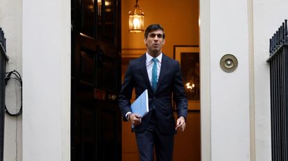 Rishi Sunak carries a copy of his Spending Review 2020 as he leaves 11 Downing Street.