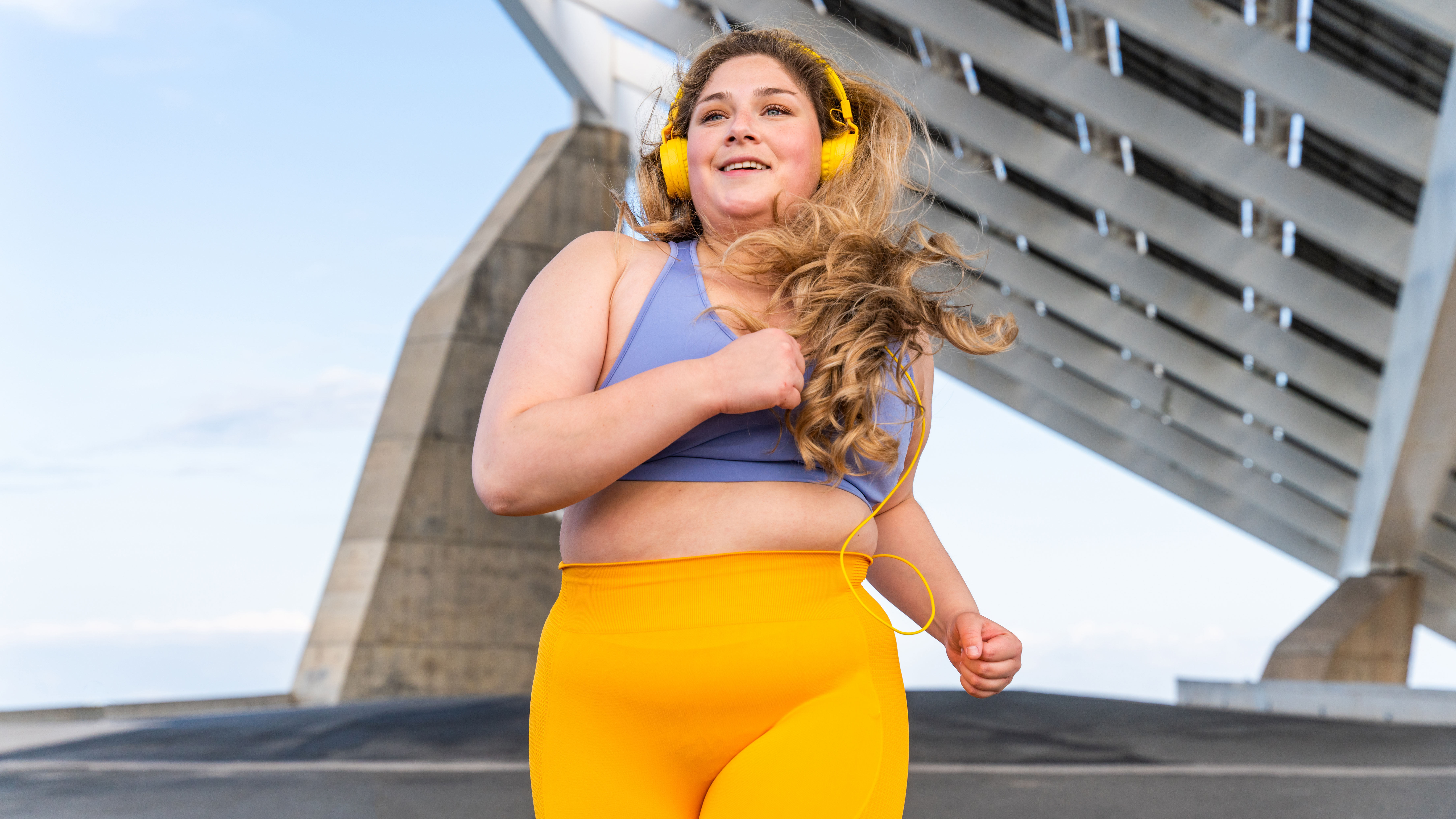 Woman running wearing headphones