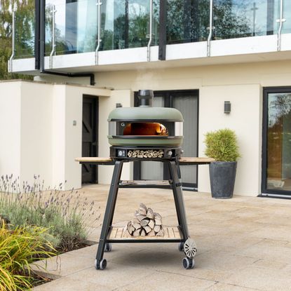 They Gozney Dome outdoor oven on a stand on a garden patio