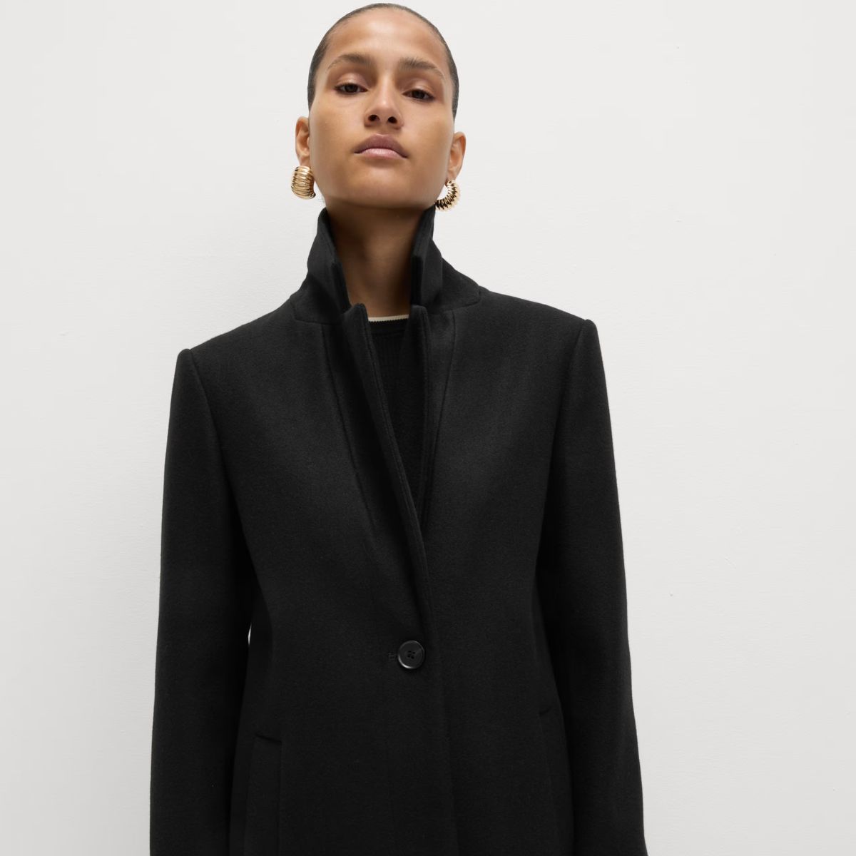 model wearing brown funnel neck COS jacket