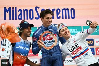 (From L) Second placed Team Jayco Alula's Australian rider Michael Matthews, first placed Alpecin-Deceuninck's Belgian rider Jasper Philipsen and third placed UAE Team Emirates' Slovenian rider Tadej Pogacar celebrate on the podium after the 115th Milan-SanRemo one-day classic cycling race, between Pavia and SanRemo, on March 16, 2024. (Photo by Marco BERTORELLO / AFP)