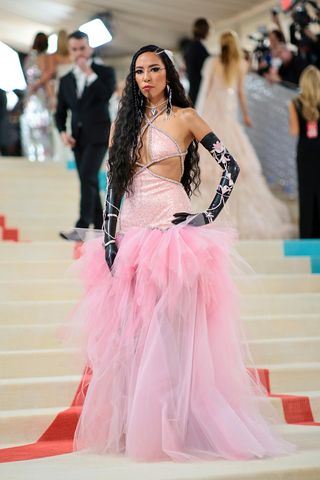 Quannah Chasinghorse chose a stunning pink frothy skirt gown with black gloves for the Met Gala 2023 red carpet
