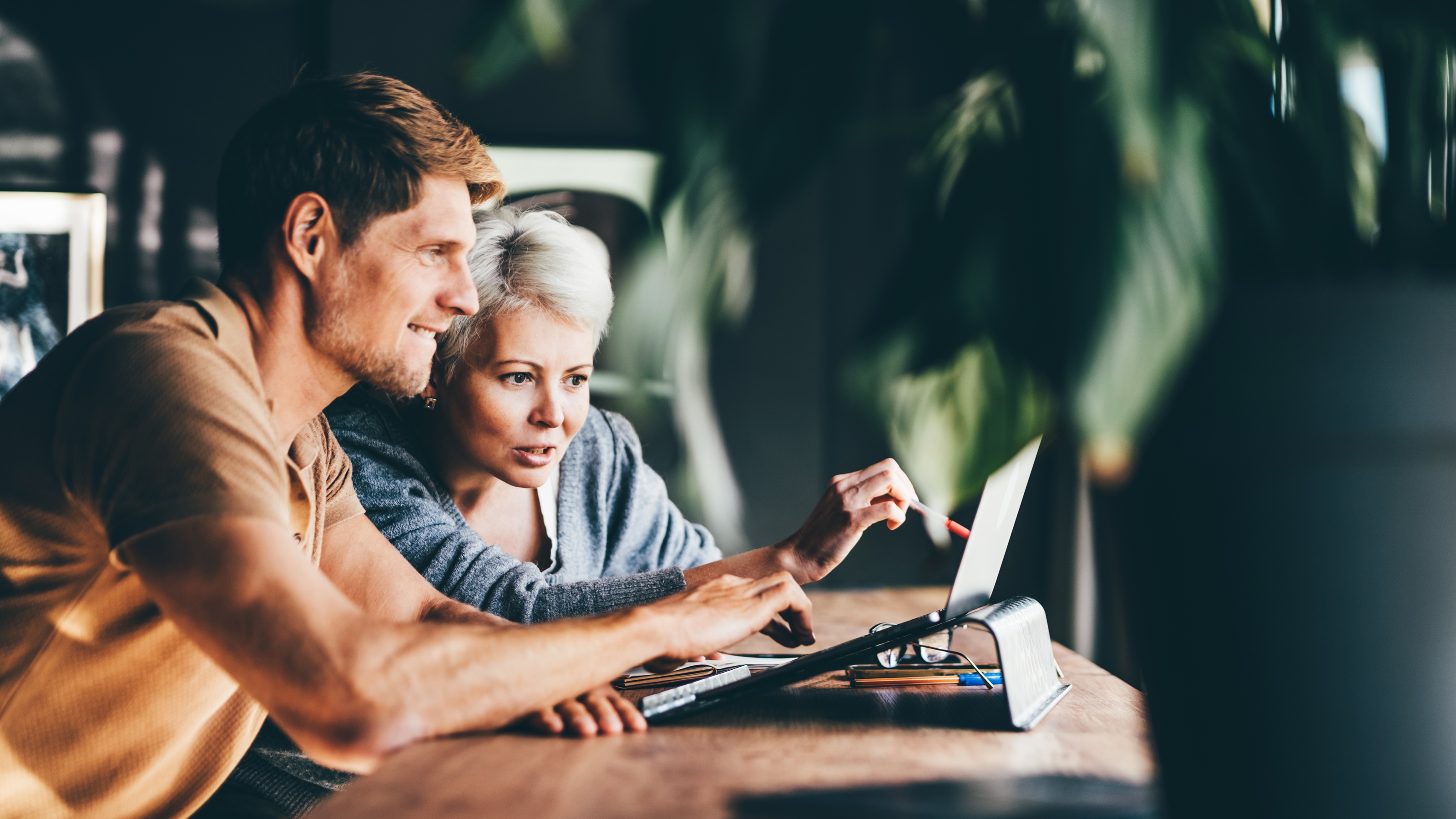 Two coworkers collaborate at work.