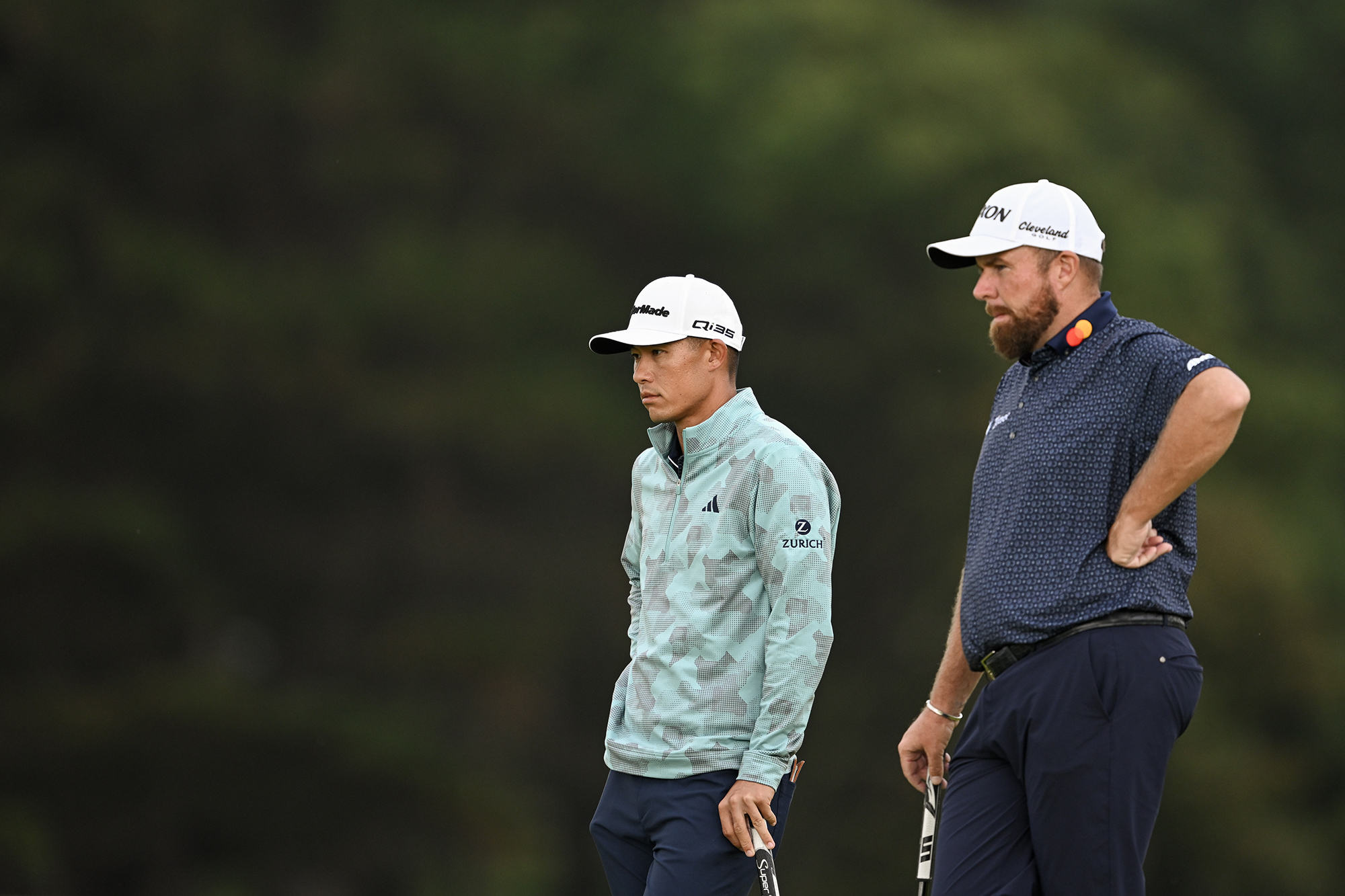 Collin Morikawa and Shane Lowry waiting to play a shot on the golf course